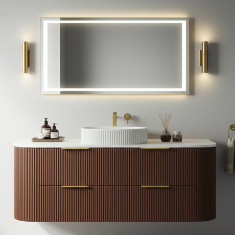 Bathroom vanity with a large illuminated mirror above it, featuring a wooden cabinet and white countertop.