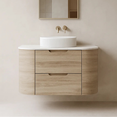 Valco 750mm curved wall hung plywood vanity in Nature Oak timber look, styled with a white fluted basin, brushed gold wall tapware, and an arch mirror in a Japandi bathroom.