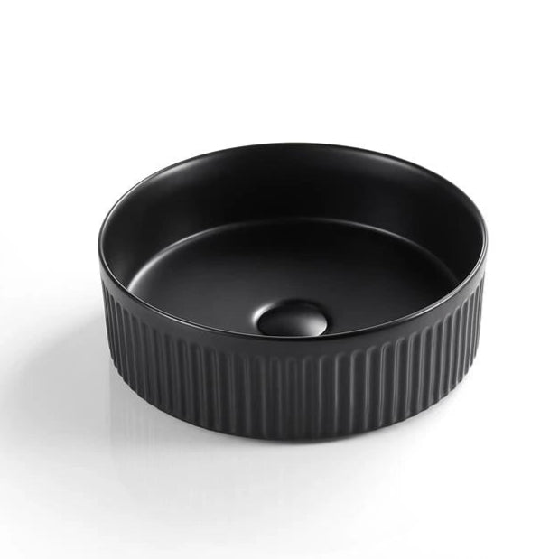 Black ceramic bowl with ribbed texture on a white background