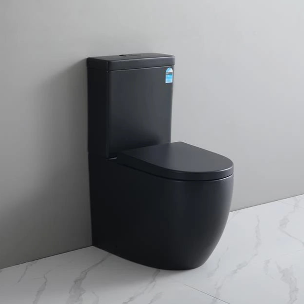 Black toilet against a gray wall in a bathroom setting
