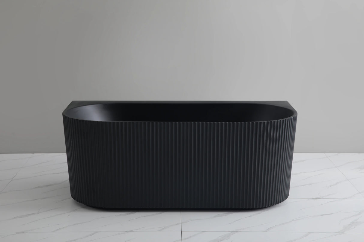 Black freestanding bathtub on a light gray floor with a neutral gray wall background