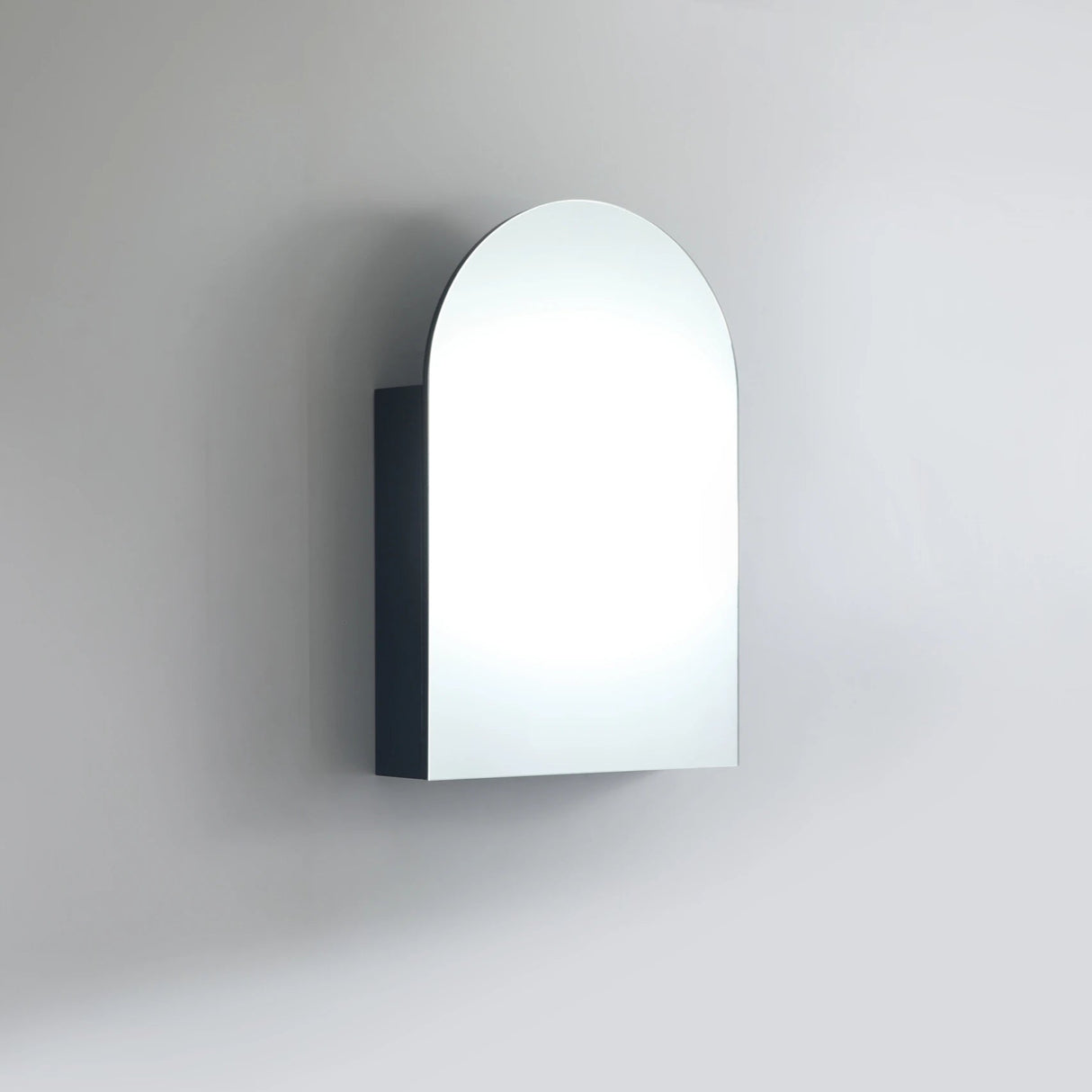 Arch-shaped wall light fixture on a plain background
