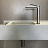 Brushed Gunmetal Aquaperla Rushy tall basin mixer installed above a vessel basin in a modern bathroom