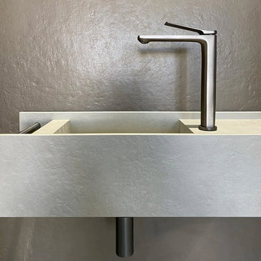 Brushed Gunmetal Aquaperla Rushy tall basin mixer installed above a vessel basin in a modern bathroom