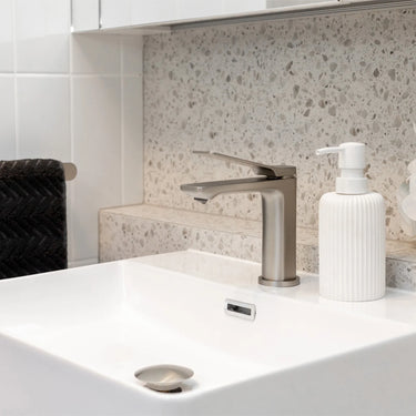 Brushed Nickel Aquaperla Rushy basin mixer installed on a bathroom vanity basin
