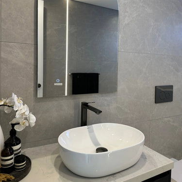 Matte Black Aquaperla Rushy tall basin mixer installed above a vessel basin in a modern bathroom