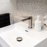Brushed Nickel Aquaperla Vog basin mixer installed on a bathroom vanity basin
