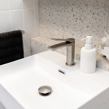 Brushed Nickel Aquaperla Vog basin mixer installed on a bathroom vanity basin