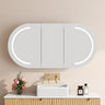 Athena pill oval LED shaving cabinet 1200mm in matte white with the front LED light on, mounted above a bathroom vanity