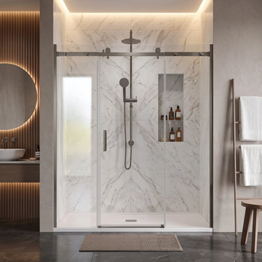 Brushed gun metal frameless 3 panel sliding shower screen with centre sliding door across a wide marble shower recess