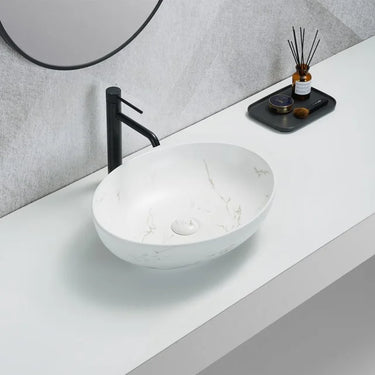 Carey 520mm oval above counter basin in white marble look with gold veins on a bathroom bench
