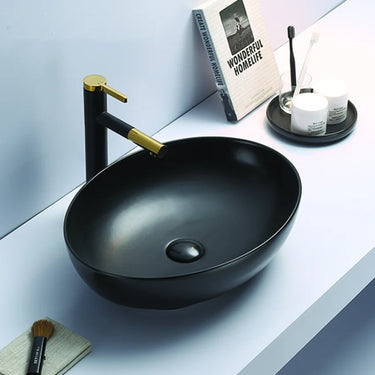 Carey 520mm oval above counter basin in matte black on a white bathroom bench