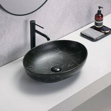 Carey 520mm oval above counter basin in matte black marble look on a bathroom bench