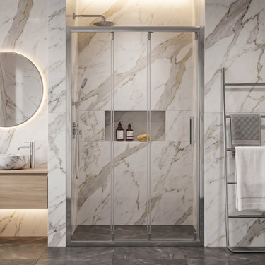 Chrome semi frameless 3 door sliding shower screen in a marble wall to wall shower recess