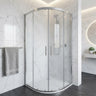 Chrome semi frameless curved sliding shower screen in a white marble bathroom corner