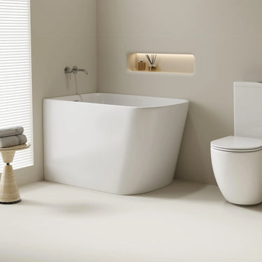 Harvard 1000mm small rectangular corner bath in gloss white installed in the corner of a compact bathroom