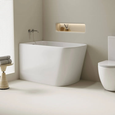 Harvard 1100mm small rectangular corner bath in gloss white installed in the corner of a compact bathroom