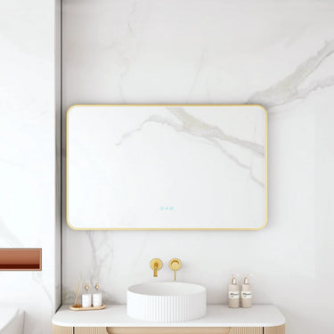 Maia 1200x750mm rectangular motion sensor LED mirror with brushed gold frame in a bathroom above a round basin