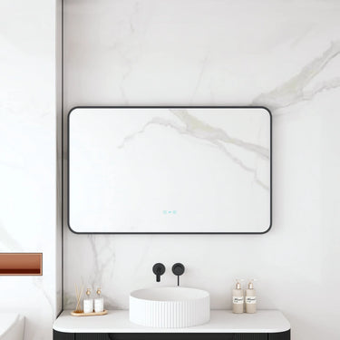 Maia 1200x750mm rectangular motion sensor LED mirror with matte black frame in a bathroom above a round basin