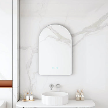 Maia 600x900mm arch motion sensor LED mirror with brushed nickel frame in a bathroom above a round basin