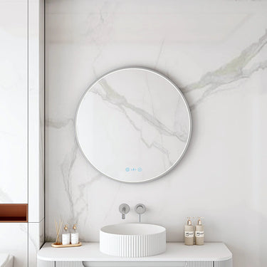 Maia 750mm round motion sensor LED mirror with brushed nickel frame in a bathroom above a round basin
