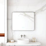 Maia 900x750mm rectangular motion sensor LED mirror with gun metal frame in a bathroom above a round basin