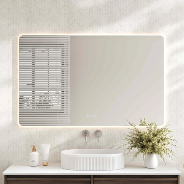 Mercio Luna 1200x750mm rectangular frameless backlit LED mirror in a bathroom above a round basin