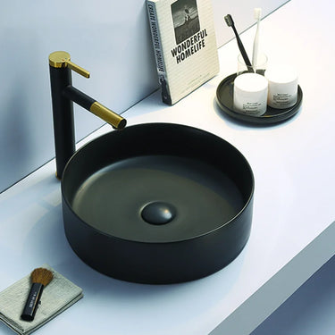 Olley 395mm round above counter basin in matte black on a bathroom vanity top