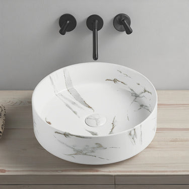 Olley 395mm round above counter basin in matte Carrara white marble look with a wall mounted mixer