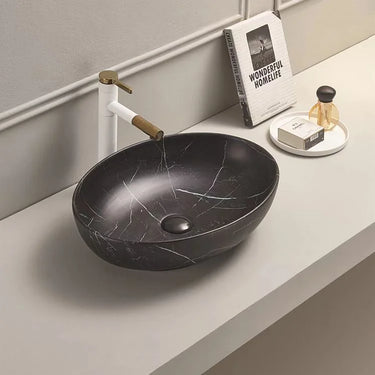 Oria 500mm oval above counter basin in matte black marble look on a bathroom bench