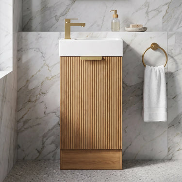 Scandinavia 450mm Prime Oak Fluted Freestanding Vanity with kickboard and poly marble basin top in a marble powder room - RJ Bathroom