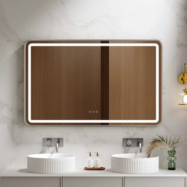 Venus 1200x750mm rectangular front-lit motion sensor LED mirror with brushed nickel frame in a bathroom above a round basin
