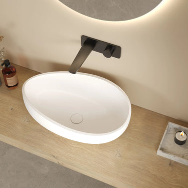Waverton 600mm solid surface stone oval above counter basin in matte white on a timber bench