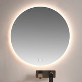 Round illuminated mirror above a sink in a bathroom setting