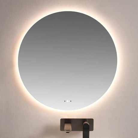 Round illuminated mirror above a sink in a bathroom setting