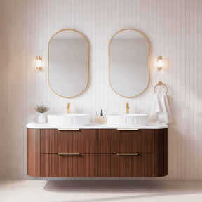 Bathroom vanity with two sinks, mirrors, and decorative items against a light wooden paneled wall.