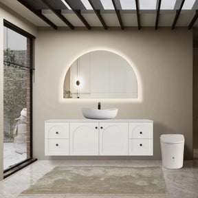 Modern bathroom with white vanity, round mirror, and freestanding bathtub.