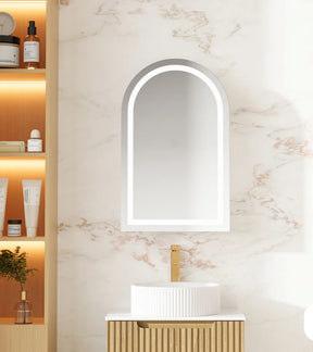 LED light shaving cabinet with an arched mirror, wall-mounted, with lighting strips inside, placed above a bathroom sink.