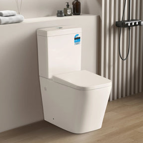 Modern toilet in a bathroom setting with towels and toiletries on a shelf.