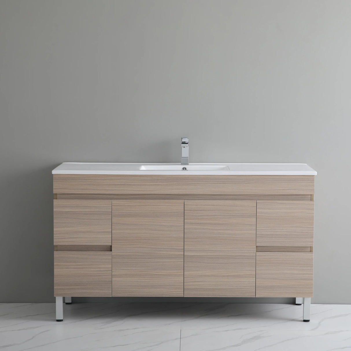 Bathroom vanity with wooden finish and white countertop against a gray wall.
