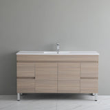 Bathroom vanity with wooden finish and white countertop against a gray wall.