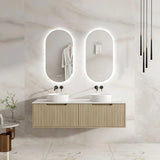 Bathroom vanity with two sinks and illuminated mirrors in a modern setting.