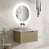 Modern bathroom with a vanity, round mirror, and decorative elements.