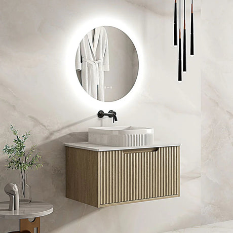 Modern bathroom with a vanity, round mirror, and decorative elements.