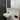 Gunmetal Aquaperla Esperia tall basin mixer installed above a vessel basin in a modern bathroom
