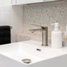 Brushed Nickel Aquaperla Rushy basin mixer installed on a bathroom vanity basin