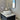 Matte Black Aquaperla Rushy tall basin mixer installed above a vessel basin in a modern bathroom