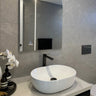 Matte Black Aquaperla Rushy tall basin mixer installed above a vessel basin in a modern bathroom