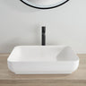 Kliff 550mm solid surface stone above counter basin in matte white on a timber vanity with black tall mixer