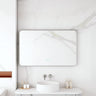 Maia 1200x750mm rectangular motion sensor LED mirror with gun metal frame in a bathroom above a round basin